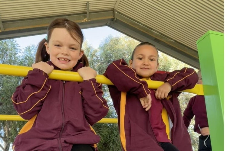 Students playing on the outside equipment
