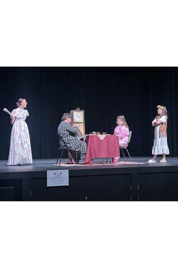 Wamoon students dressed in old fashioned clothes on stage during their play of 'Fearless'